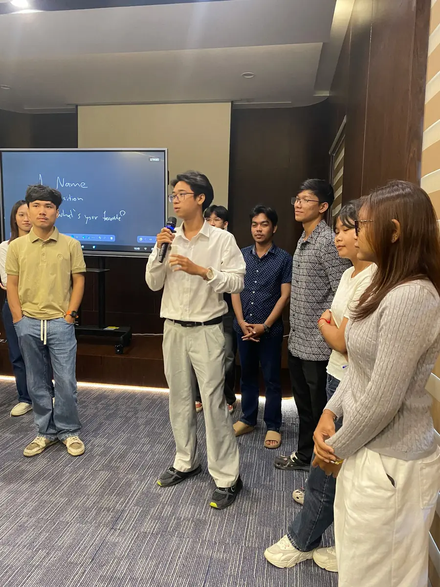 Speaking at a Cambodia Blockchain Summit community session with a microphone